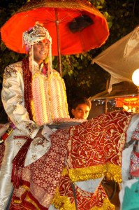 Groom leads the parade to the wedding on horseback